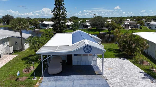 an aerial view of a house with table and chairs