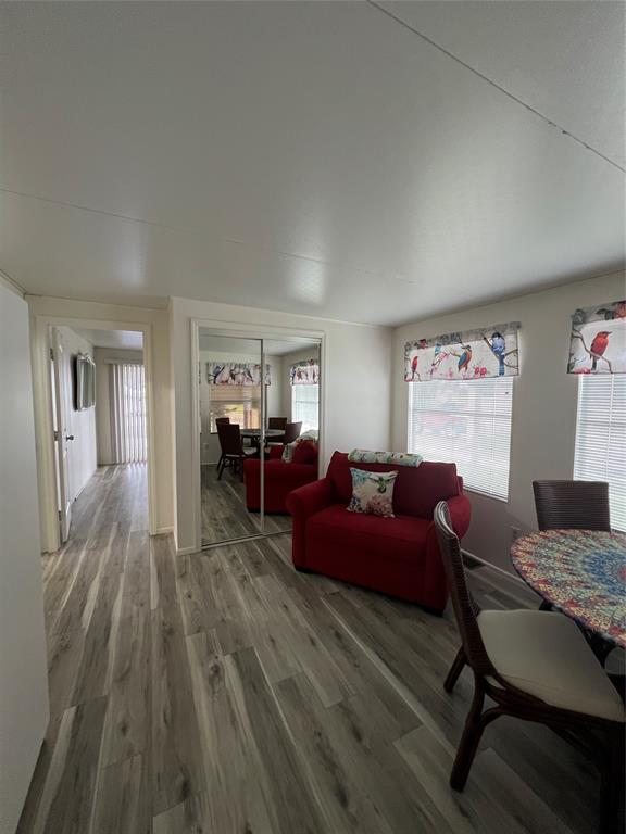13891 Southeast 126th Boulevard, Unit 121 Okeechobee, FL 34974 - Photo 16 of 45 a living room with furniture and a wooden floor