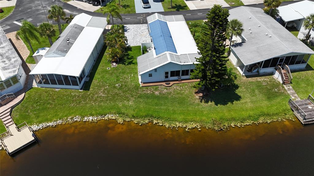 13891 Southeast 126th Boulevard, Unit 121 Okeechobee, FL 34974 - Photo 2 of 45 an aerial view of a house with garden space and street view
