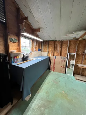 a view of a room with window and furniture