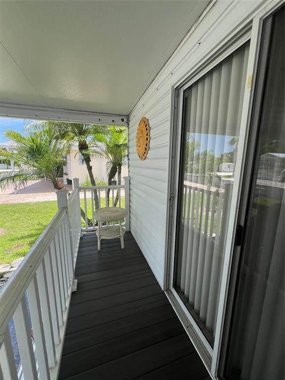 13891 Southeast 126th Boulevard, Unit 121 Okeechobee, FL 34974 - Photo 27 of 45 a view of balcony with wooden floor