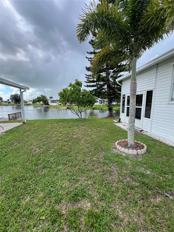 13891 Southeast 126th Boulevard, Unit 121 Okeechobee, FL 34974 - Photo 30 of 45 a swimming pool with outdoor seating and yard