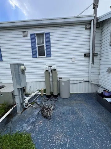 a view of a backyard with chairs and a grill