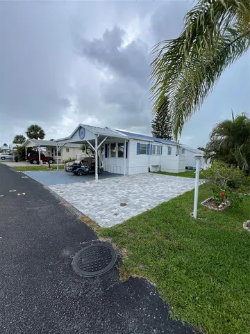 a view of a house with a yard and sitting area