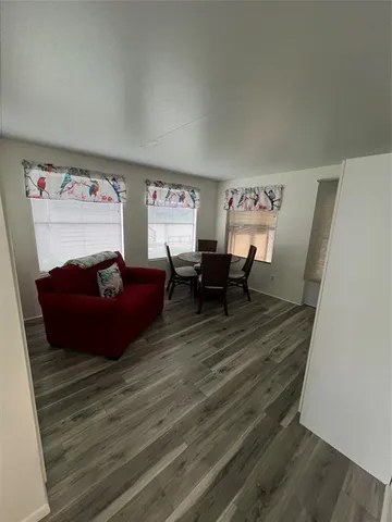 a living room with furniture wooden floor and a flat screen tv