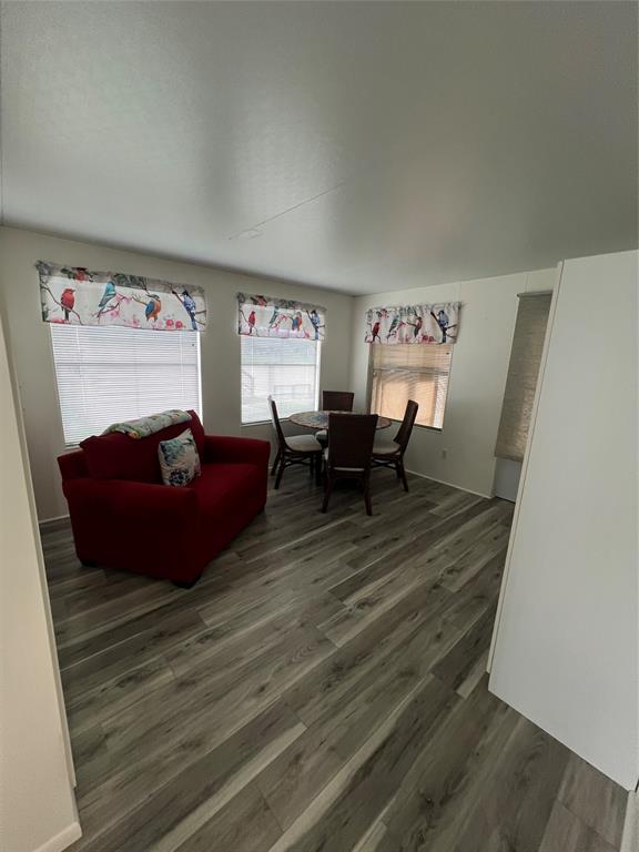 13891 Southeast 126th Boulevard, Unit 121 Okeechobee, FL 34974 - Photo 10 of 45 a living room with furniture wooden floor and a flat screen tv