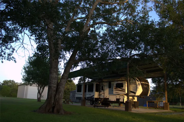 a living room with furniture and a refrigerator