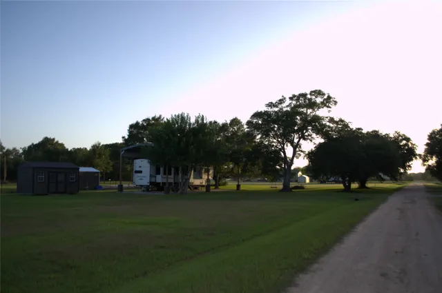 a view of road with grass and trees