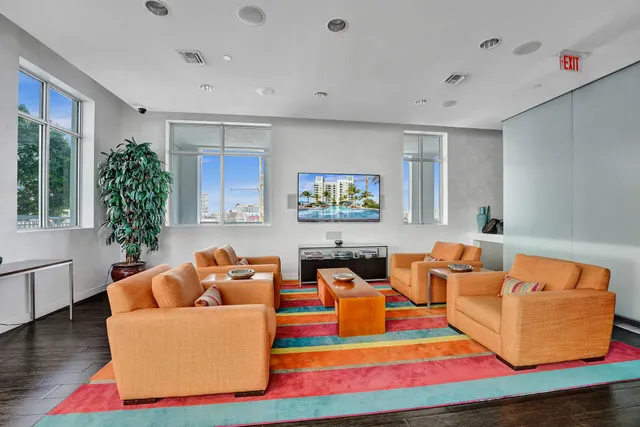 a room with pool table and windows