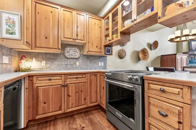 a kitchen with stainless steel appliances granite countertop a sink and cabinets