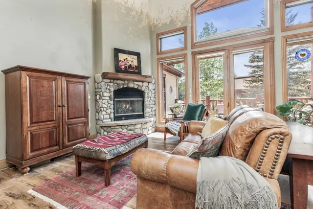 a living room with furniture fireplace and a large window
