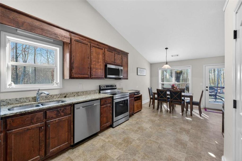 336 Dixie Ct Mount Mount Airy, GA 30563 - Photo 11 of 41 a kitchen with lots of counter top space sink and stainless steel appliances
