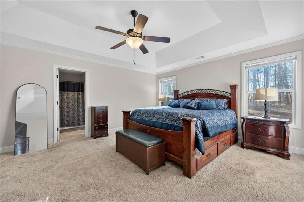 336 Dixie Ct Mount Mount Airy, GA 30563 - Photo 18 of 41 a bedroom with a bed and a chandelier