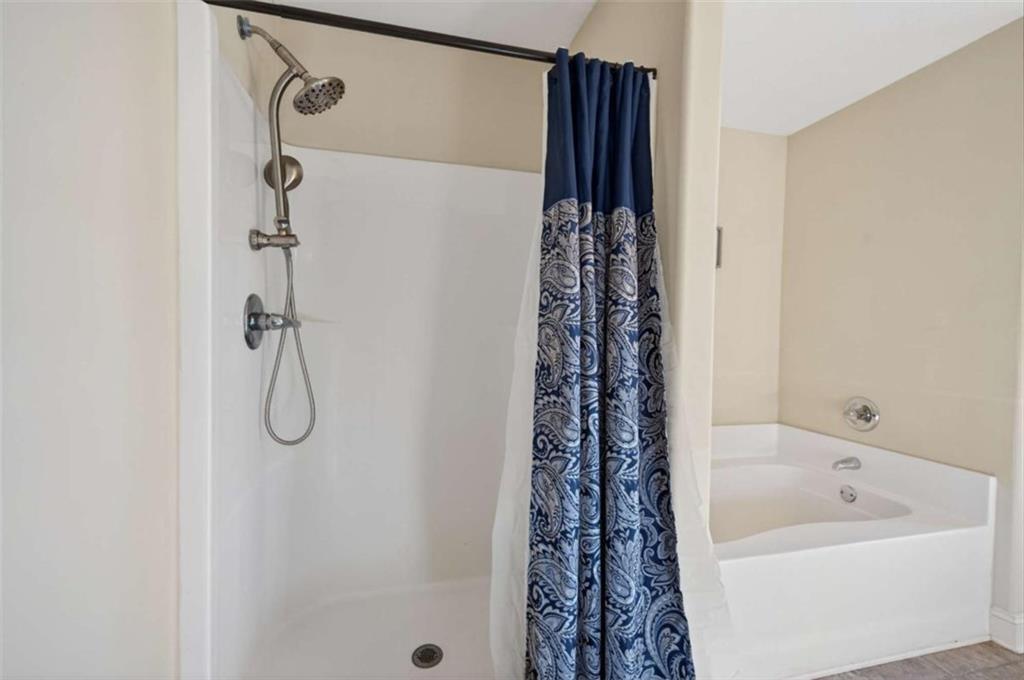 336 Dixie Ct Mount Mount Airy, GA 30563 - Photo 22 of 41 a bathroom with a bath tub and shower