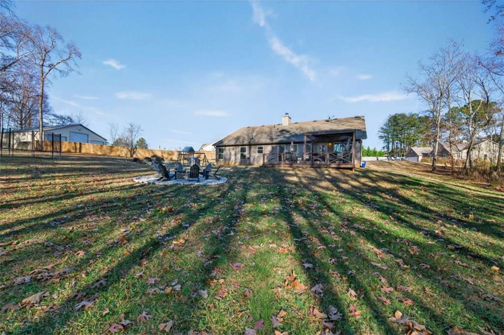 336 Dixie Ct Mount Mount Airy, GA 30563 - Photo 34 of 41 a view of a swimming pool with an outdoor seating and a garden