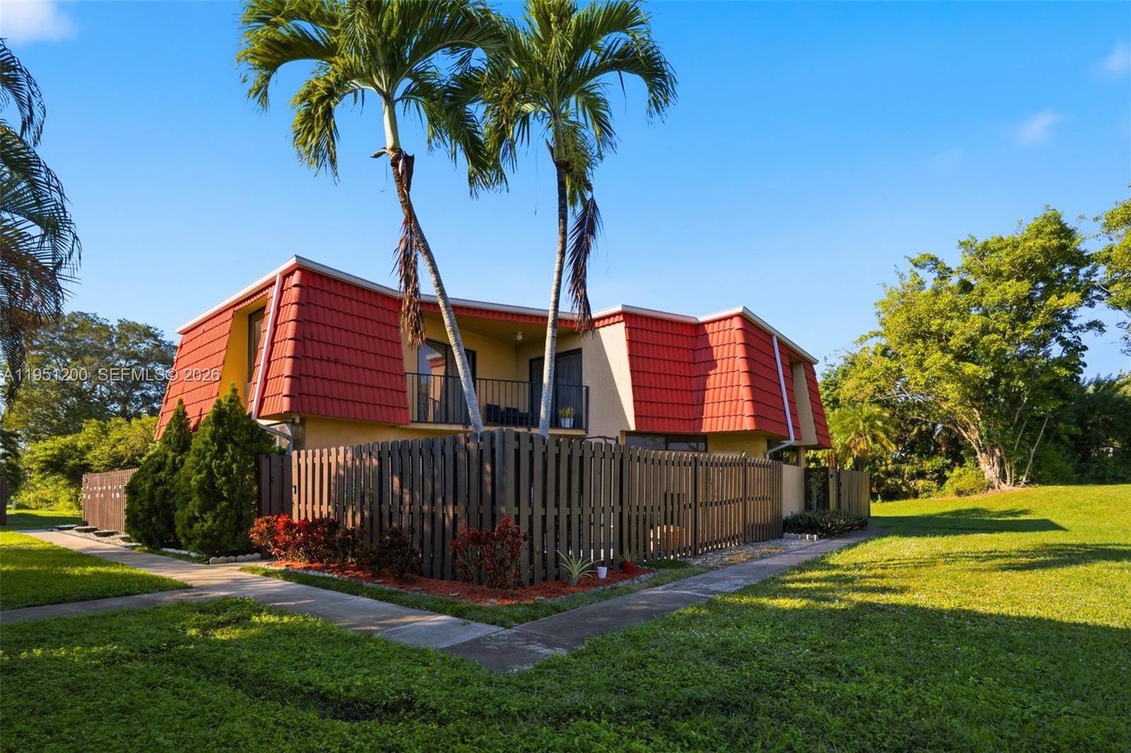23024 Oxford Place, Unit C Boca Raton, FL 33433 - Photo 1 of 22 a view of a house with a yard and potted plants