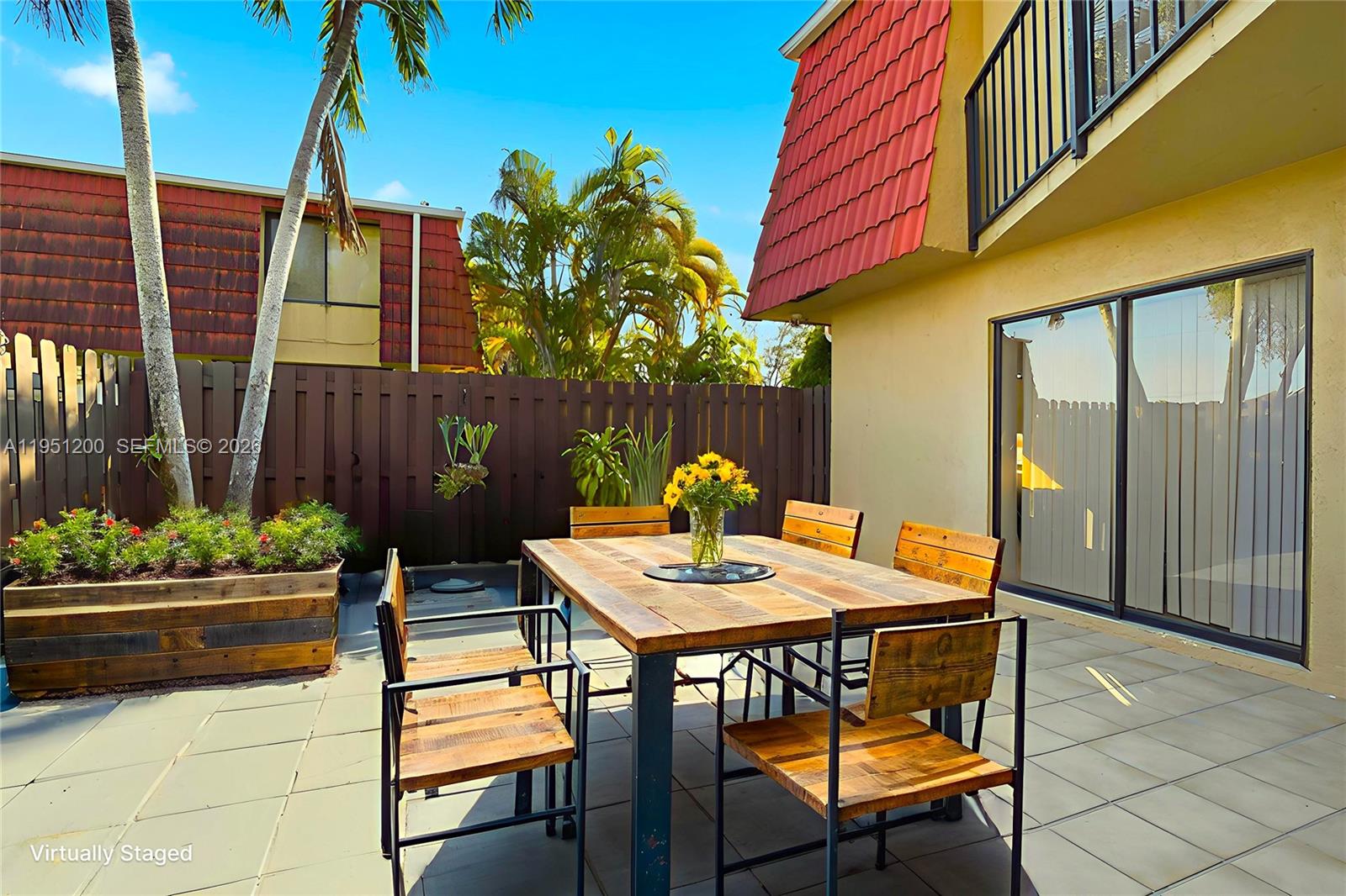 23024 Oxford Place, Unit C Boca Raton, FL 33433 - Photo 18 of 22 a table and chairs in front of a building