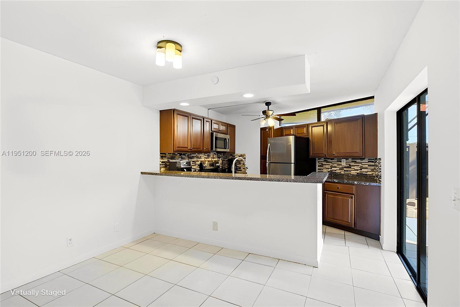 23024 Oxford Place, Unit C Boca Raton, FL 33433 - Photo 4 of 22 a kitchen with stainless steel appliances granite countertop a refrigerator and a stove top oven