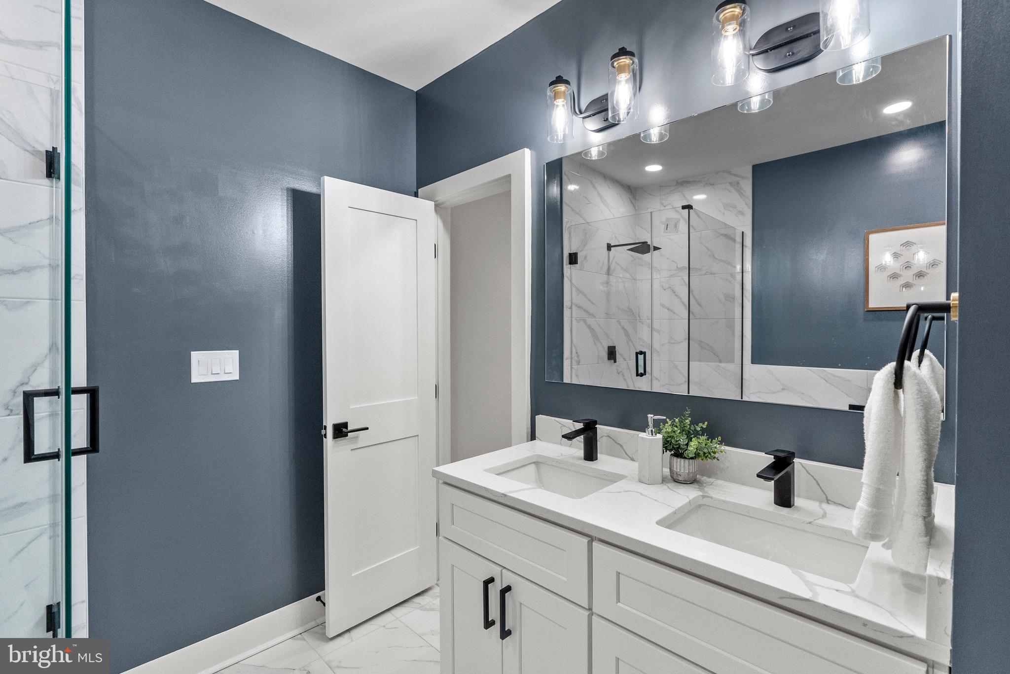 2019 M Street Northeast, Unit 1 Washington, DC 20002 - Photo 24 of 31 a bathroom with a sink a shower and a mirror
