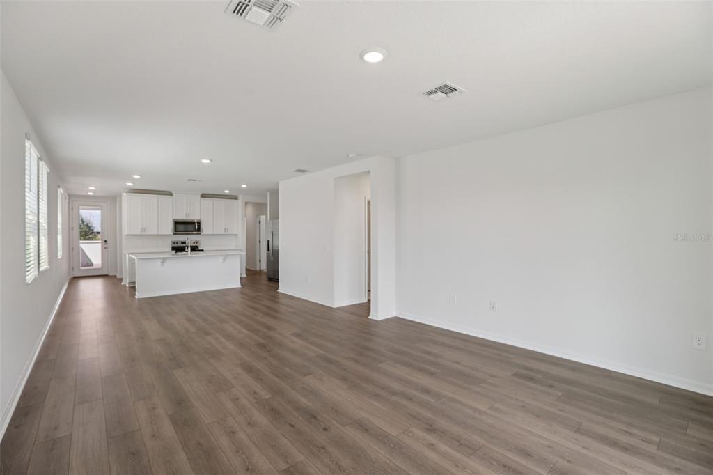 643 Pennywort Street Lake Alfred, FL 33850 - Photo 12 of 47 a view of a kitchen with a sink and wooden floor