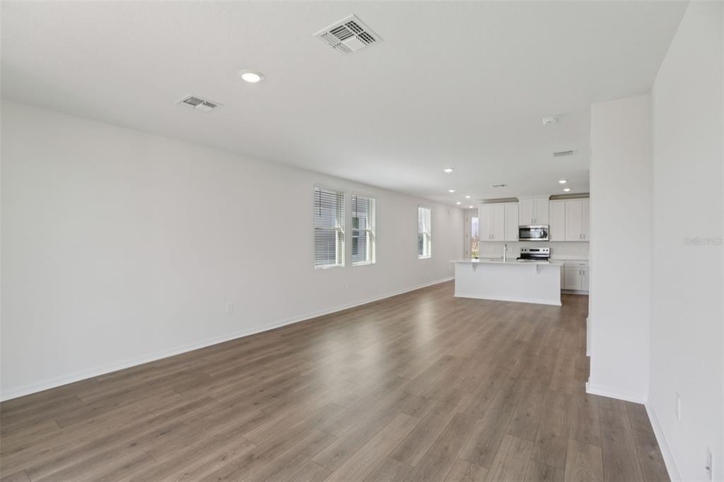 643 Pennywort Street Lake Alfred, FL 33850 - Photo 13 of 47 a view of a kitchen with wooden floor and windows