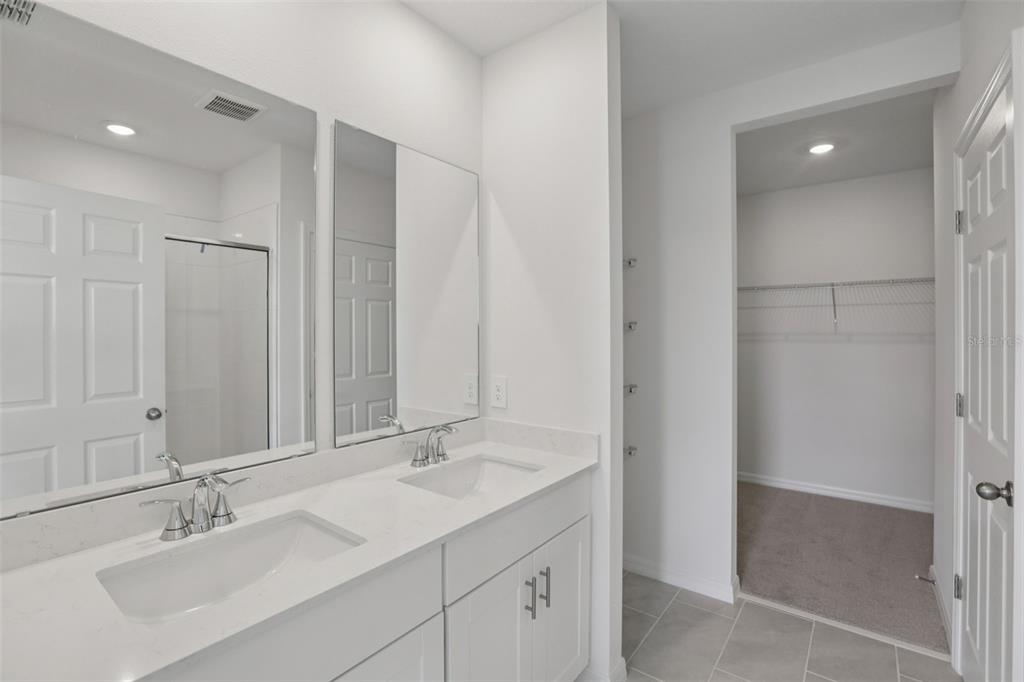 643 Pennywort Street Lake Alfred, FL 33850 - Photo 24 of 47 a bathroom with double sink and a mirror