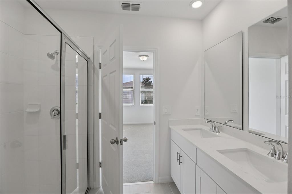 643 Pennywort Street Lake Alfred, FL 33850 - Photo 26 of 47 a bathroom with a double vanity sink a mirror and shower