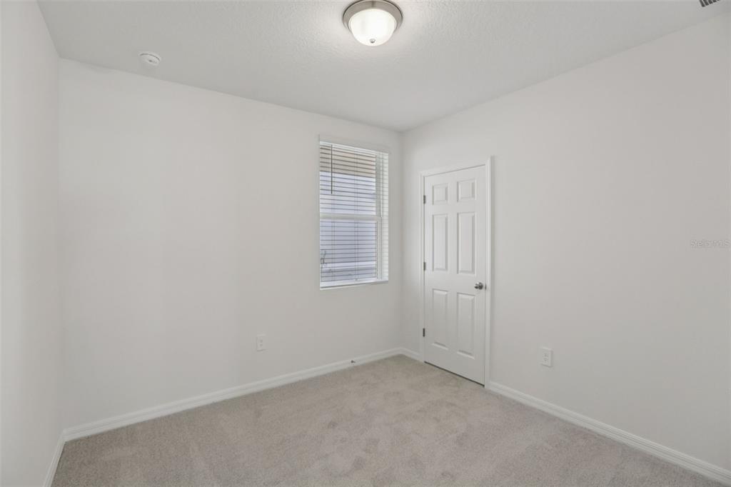 643 Pennywort Street Lake Alfred, FL 33850 - Photo 32 of 47 an empty room with windows and closet