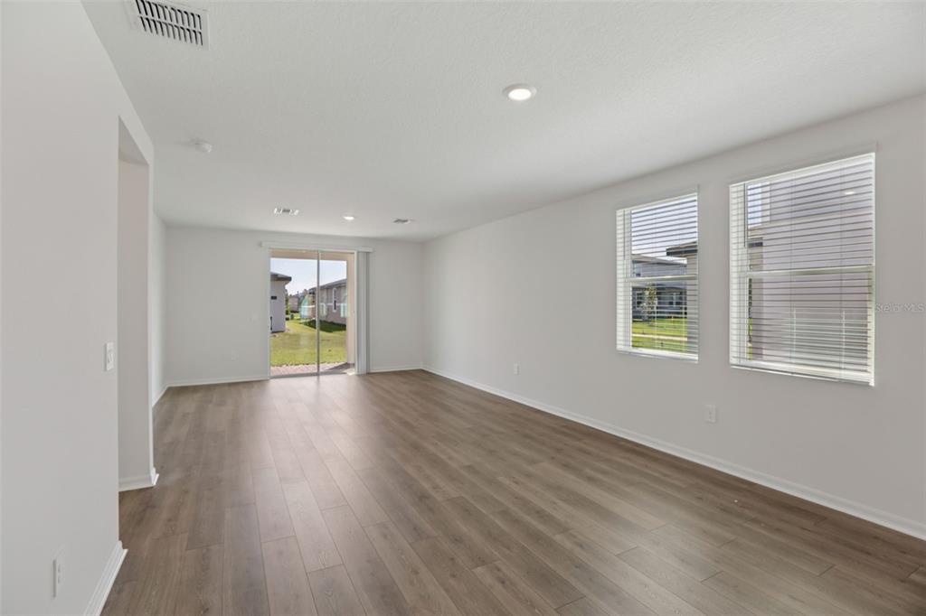 643 Pennywort Street Lake Alfred, FL 33850 - Photo 9 of 47 a view of an empty room with wooden floor and a window