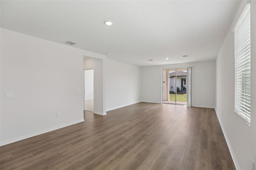 643 Pennywort Street Lake Alfred, FL 33850 - Photo 10 of 47 a view of an empty room with wooden floor and a window