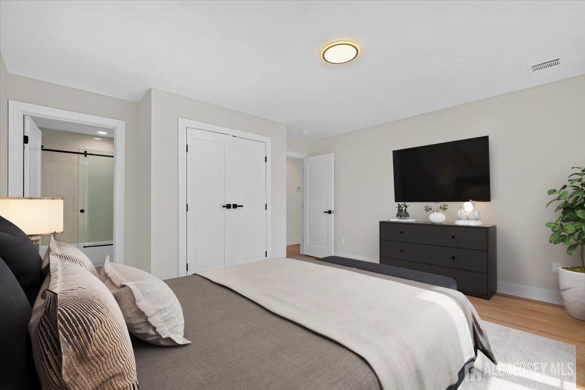 30 Ashley Road Edison, NJ 08817 - Photo 19 of 39 a bedroom with a bed and a flat screen tv