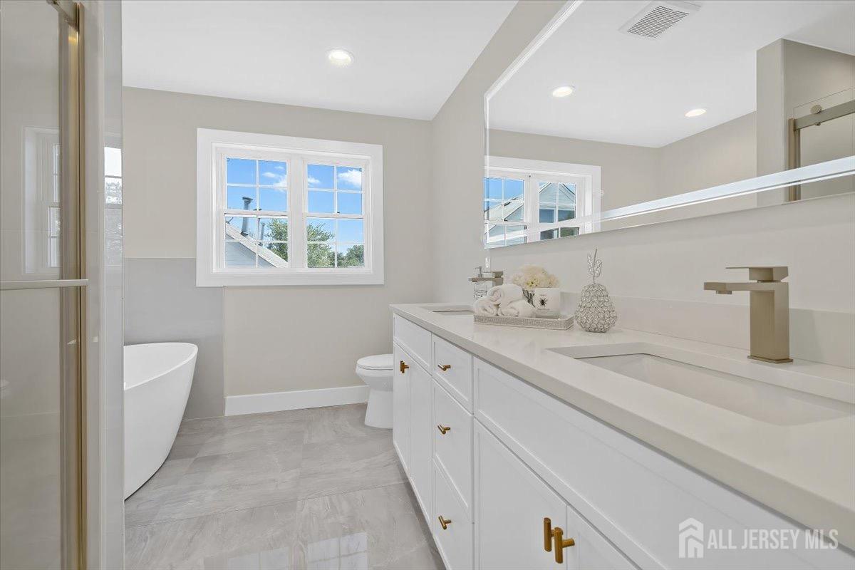 30 Ashley Road Edison, NJ 08817 - Photo 20 of 39 a spacious bathroom with a double vanity sink toilet and a tub