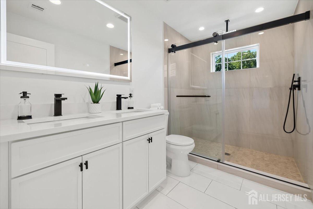 30 Ashley Road Edison, NJ 08817 - Photo 24 of 39 a bathroom with a shower sink vanity mirror and toilet