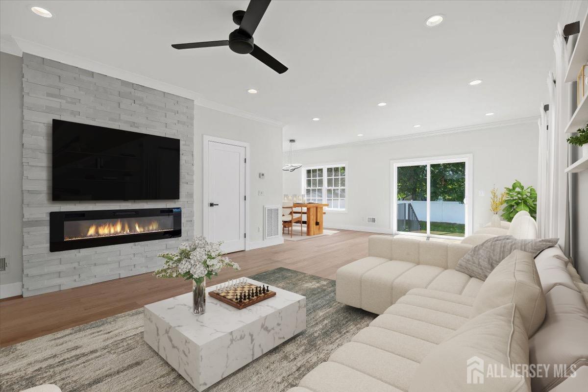 30 Ashley Road Edison, NJ 08817 - Photo 3 of 39 a living room with furniture a flat screen tv and a fireplace