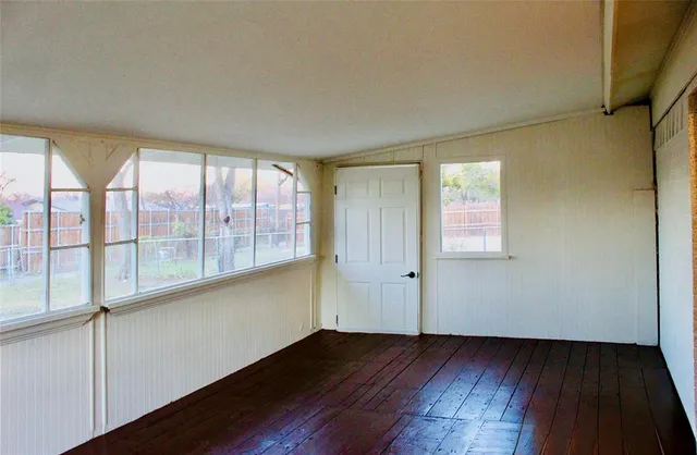 a house that has a tree in front of it