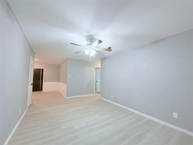 a view of a room with wooden floor