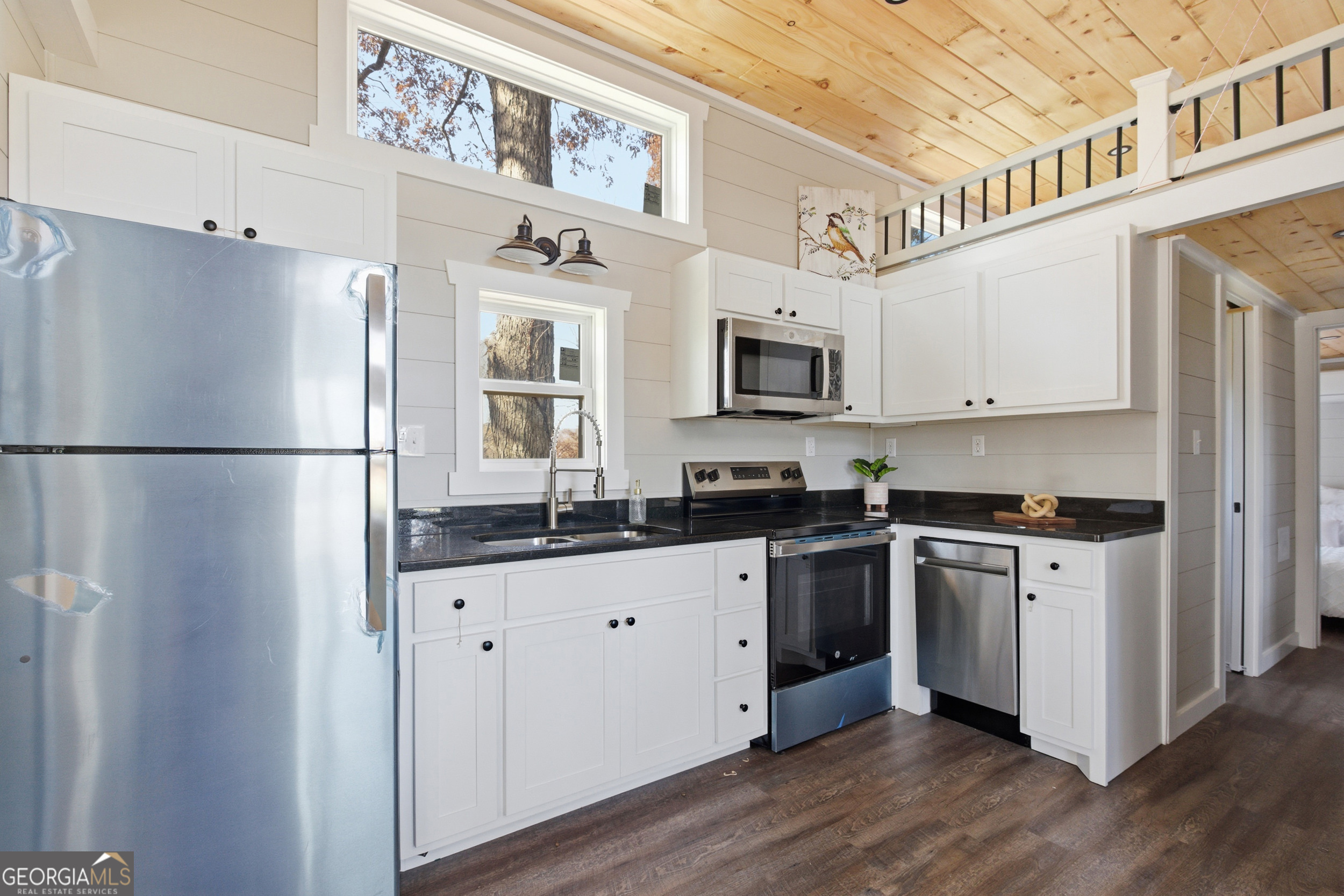 527 Saunders Road Franklin, NC 28734 - Photo 13 of 25 a kitchen with granite countertop a refrigerator stove top oven and sink