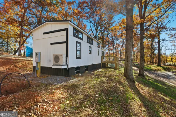 a view of a house with a yard covered in snow