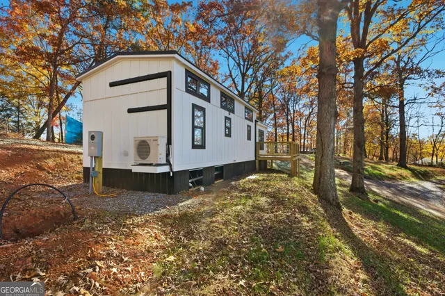 a view of a house with a yard covered in snow