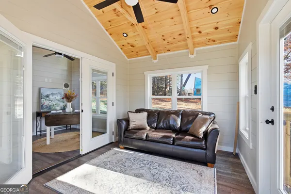 a living room with furniture and wooden floor