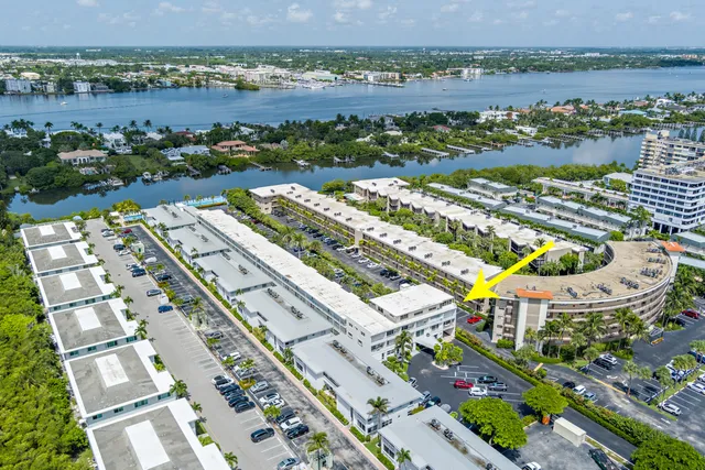 a view of multiple houses with yard swimming pool and outdoor seating
