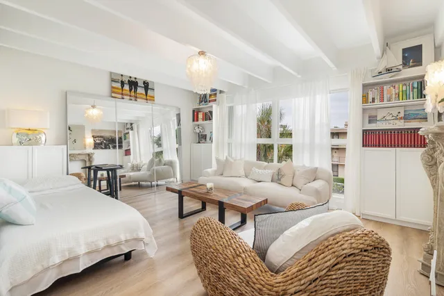 a bedroom with furniture and a large window