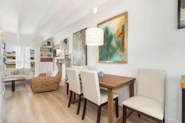 a living room with furniture and a painting on the wall