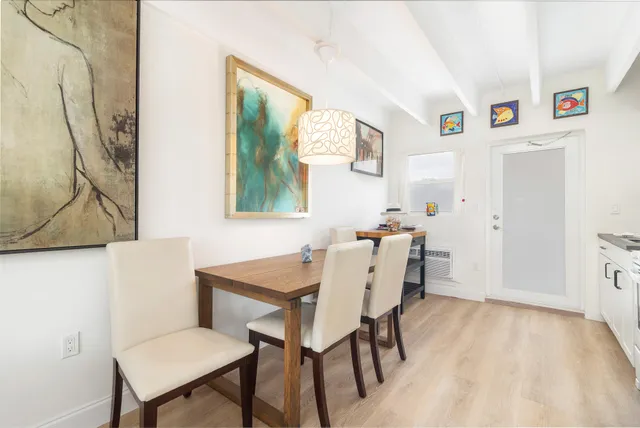a view of a dining room with furniture and a potted plant