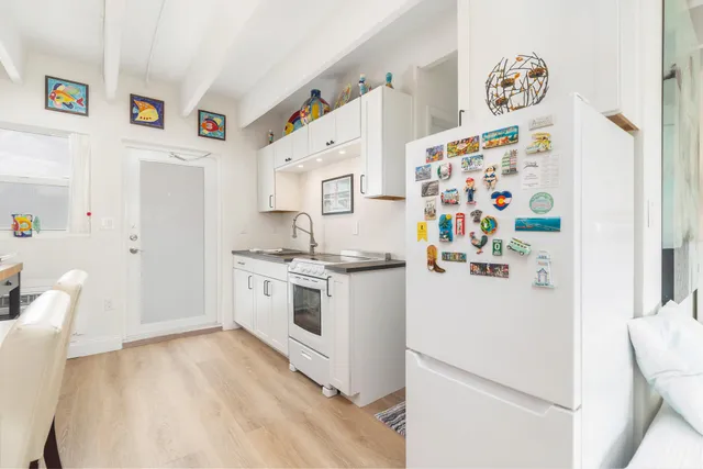 a white refrigerator freezer sitting inside of a kitchen