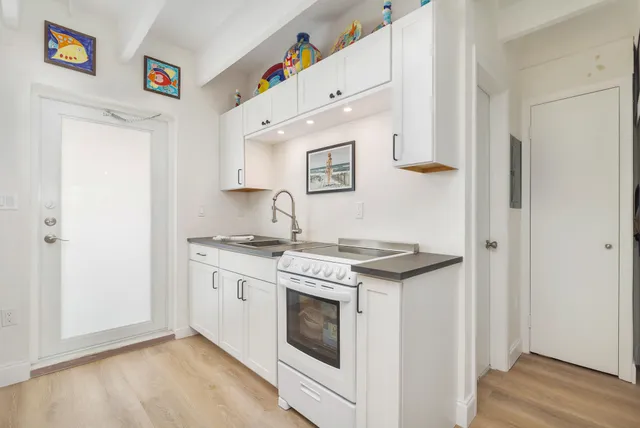 a kitchen with stainless steel appliances granite countertop a stove and a refrigerator
