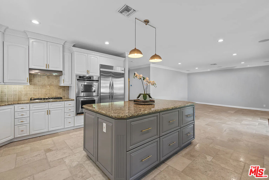 4724 Noble Avenue Sherman Oaks, CA 91403 - Photo 13 of 35 a kitchen with a sink window and cabinets