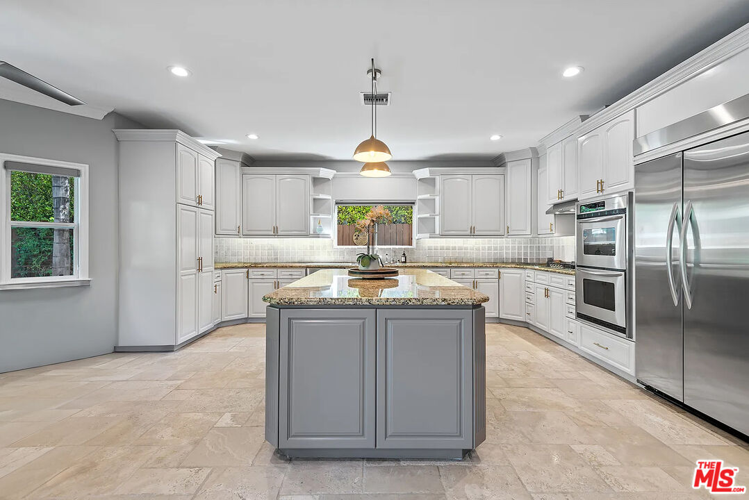 4724 Noble Avenue Sherman Oaks, CA 91403 - Photo 15 of 35 a kitchen with stainless steel appliances granite countertop a stove a sink a refrigerator and a refrigerator