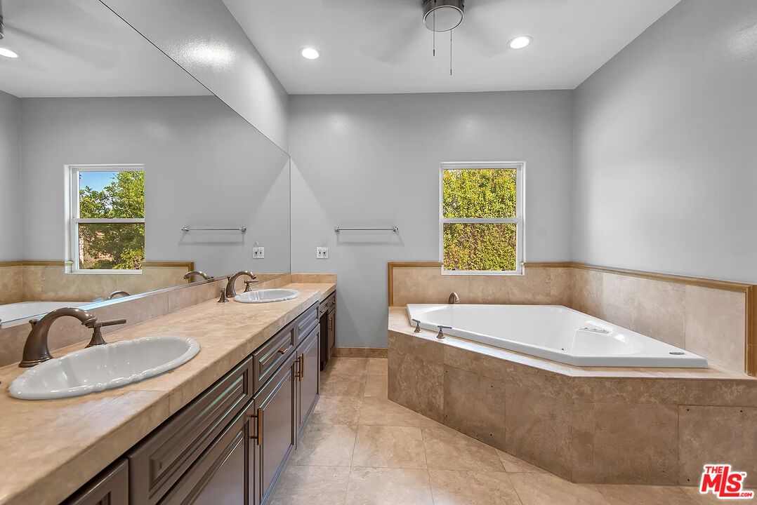 4724 Noble Avenue Sherman Oaks, CA 91403 - Photo 18 of 35 a bathroom with a granite countertop sink and a bathtub