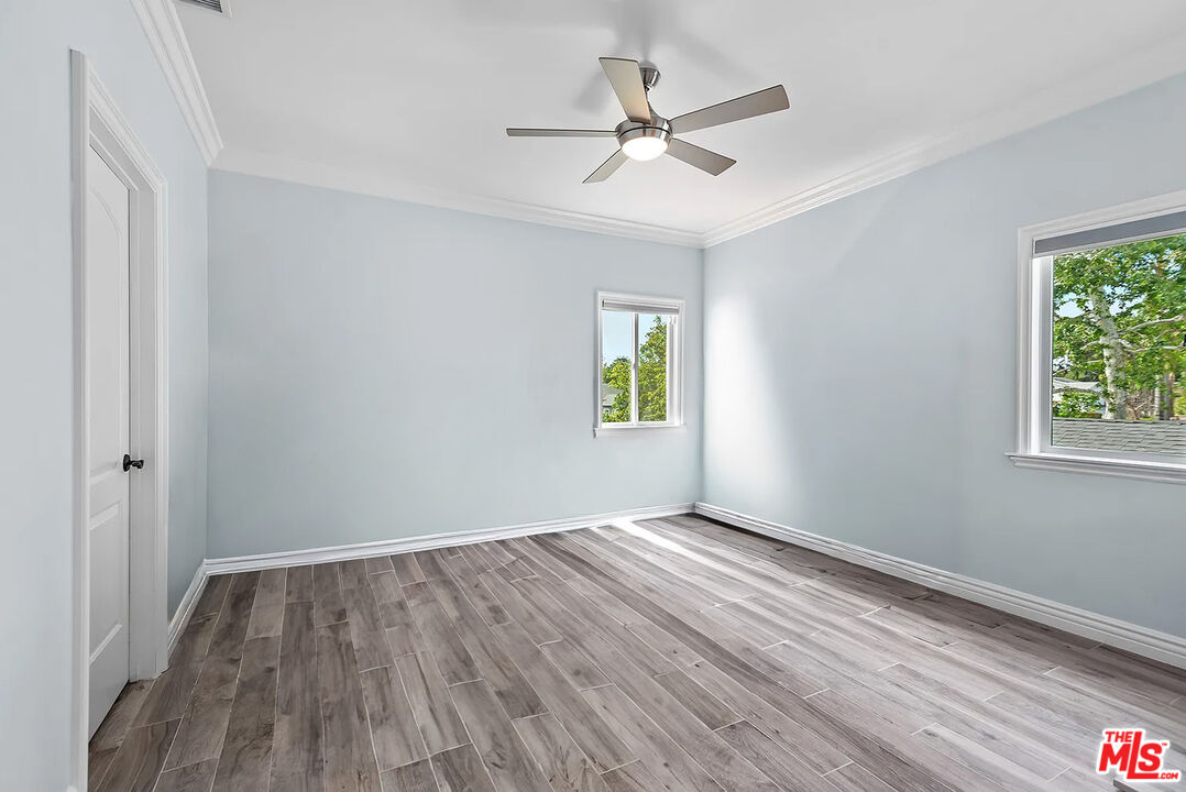 4724 Noble Avenue Sherman Oaks, CA 91403 - Photo 20 of 35 a view of an empty room with wooden floor and a window